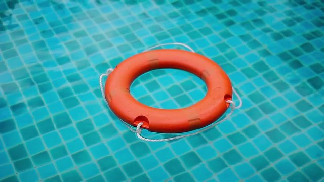 The lifebuoy floats in the pool