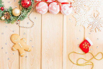 Christmas background with decorations, gingerbread and balls on wooden board