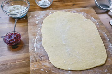 Preparing fresh croissants with jam