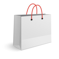 Classic paper shopping bag with red rope handles isolated