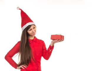 Long-haired girl in red christmas cap and red gift box