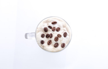 Capuccino in glass cup isolated on white. Top view