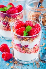 Healthy breakfast: yogurt parfait with granola and fresh raspberries