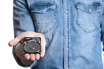 Man's hand holds a 2.5 inch hard drive. Isolated on white background.