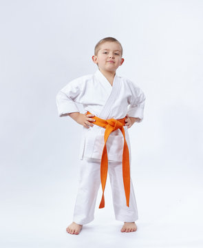 On a white background little athlete in karategi