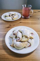 Freshly baked croissants with rose jam