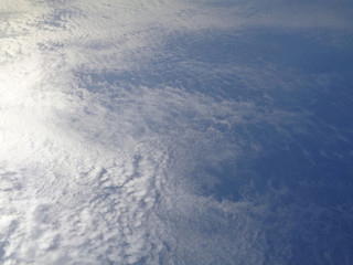 Blue sky in haze of white clouds