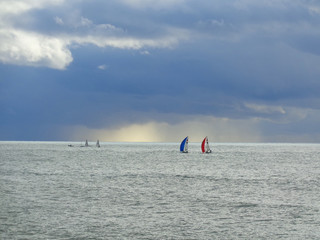 Naklejka premium Sailing boats in the sea, sky with clouds