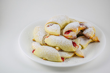 Freshly baked croissants with rose jam