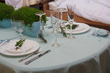 Christmas table setting with glasses of fir branches