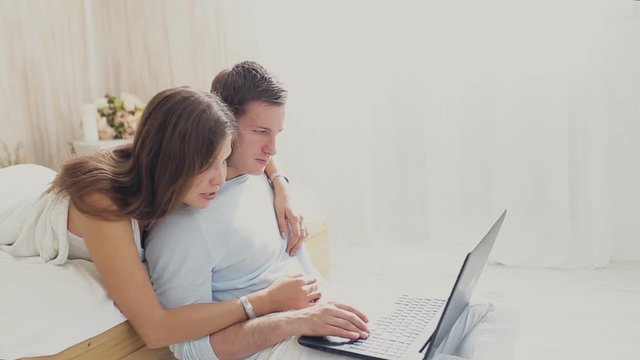 loving couple with laptop at home