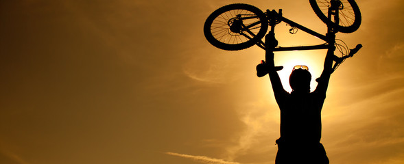 Silhouette of a man with a bike
