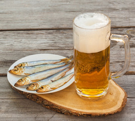 Glass of beer with a snack on a wooden table