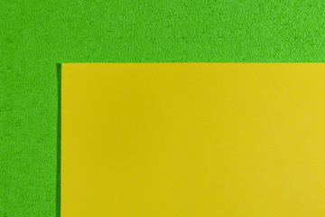 Eva foam ethylene vinyl acetate smooth lemon yellow surface on apple green sponge plush background