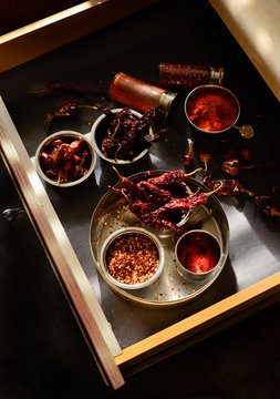 Red chillies and spices in open drawer