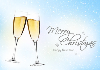 Two champagne glasses over christmas background