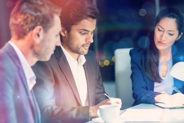 Group of businesspeople looking at document