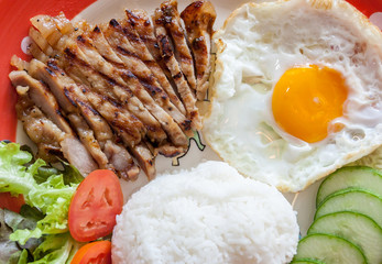 Thai Food grilled pork with fried egg.