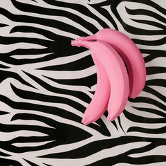 Pink bananas on zebra texture. Minimal style. Flat lay.