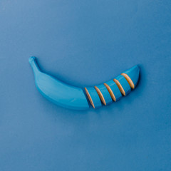 Blue banana on blue pastel background. Minimal style. Food conce