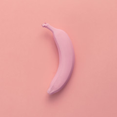 Pink banana on pink background. Minimal style. Flat lay. Food co