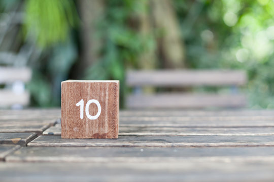 Wooden Cube. Block of wooden with numbers ten on natural background.