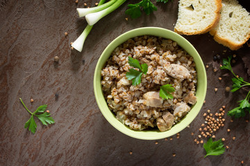 Buckwheat with meat goulash on a stone background. The concept o