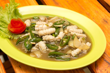 Squid cuisine served with spicy sour filling sauce, green sweet chili, and onion.