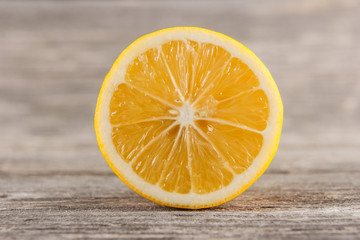 Half of lemon on gray board/Close up of lemon