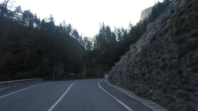 Long drive on mountain road, curvy road and a dark tunnel, Bicaz Gorge, Romania