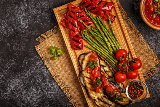 Grilled vegetables with tomato sauce and fresh herbs.