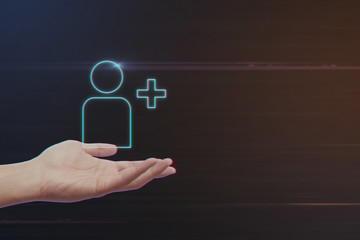 Human Hand Holding Add Friend Icon on Light Motion Background and Lens Flare - Digital 3d Effect Style Color