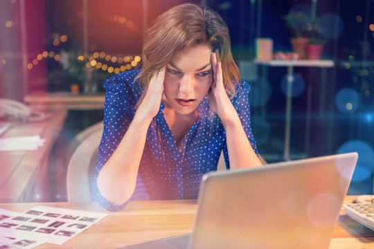 Stressed businesswoman sitting at desk