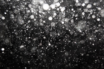 Falling snow on black background