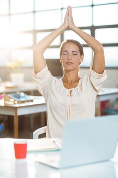 Female Business Executive Performing Yoga