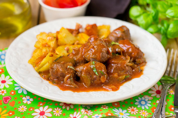 Beef meatballs in tomato gravy with pickles gherkins