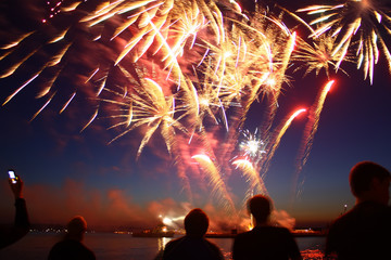New year fireworks above water with reflection on the black sky background