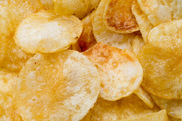 Close up potato chips on wood top view background.