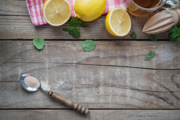 Fototapeta na wymiar Wooden Table with Fresh Lemon and Mint Leaves - Drink Menu Background