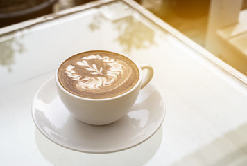 Glass of coffee on table,warm toned