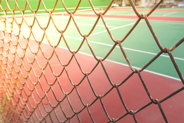 tennis court behind wire fence