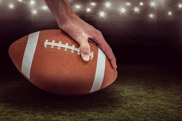 Composite image of american football player placing the ball  3D