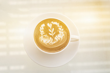 Hot coffee cup on white table with space in warm tone