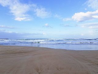 Deserted beach near the blue sea