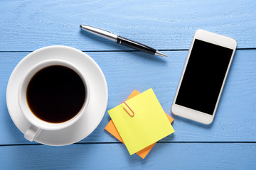 office supplies with cup of coffee and mobile telephone, view from above