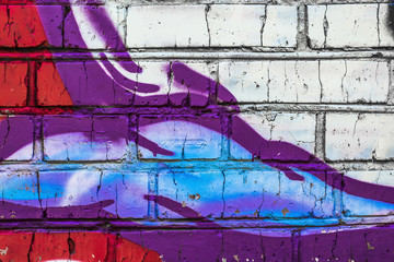 Brick wall with grafitti. Colorful painted close up