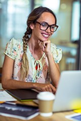 Smiling graphic designer using laptop