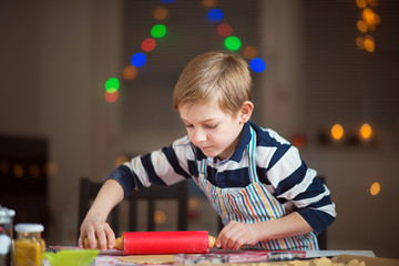 Happy little child preparing cookies for Christmas and New Year