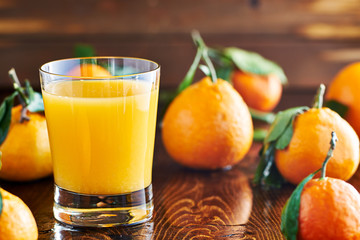 fresh glass of orange juice on rustic table top