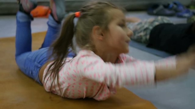 Cute little girl doing gymnastics exercises in sports hall, Children doing sports